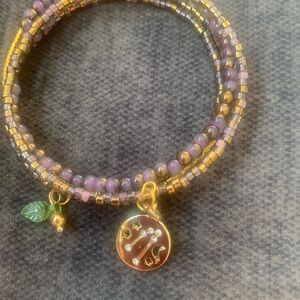 Elegant Gold and Purple Beaded Bracelet with Zodiac Charm